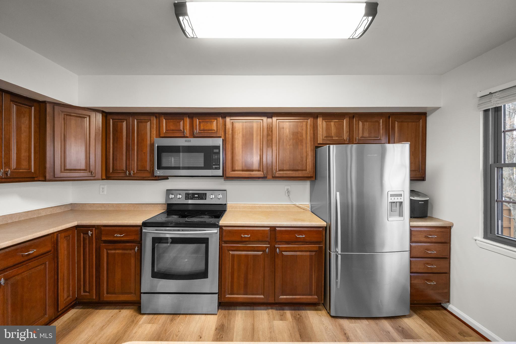 33 Badger Gate Court Baltimore, MD 21228 - Photo 14 of 39 a kitchen with a refrigerator stove and microwave