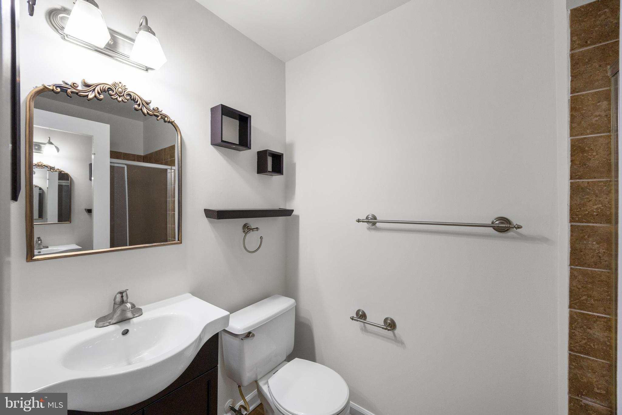 33 Badger Gate Court Baltimore, MD 21228 - Photo 25 of 39 a bathroom with a sink toilet and mirror