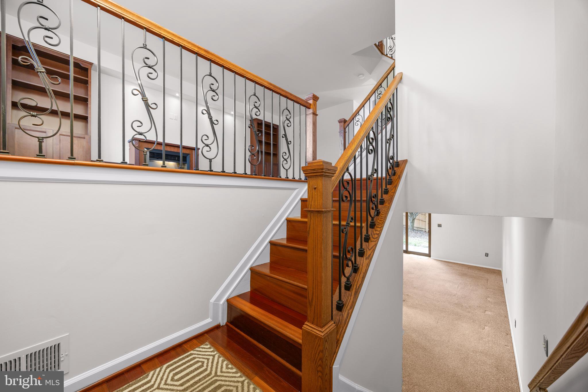 33 Badger Gate Court Baltimore, MD 21228 - Photo 3 of 39 a view of staircase with lots of frames on wall and a window