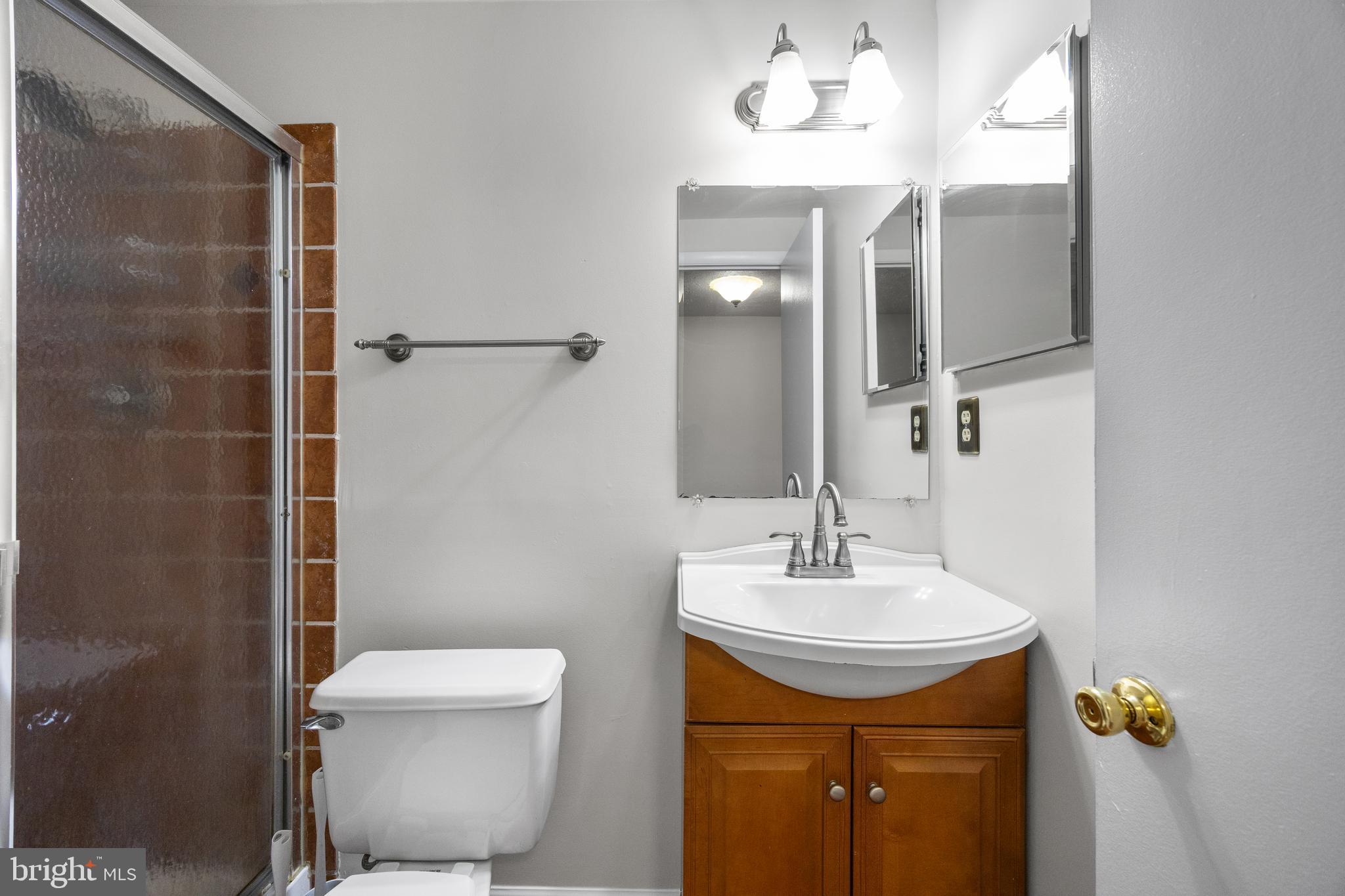 33 Badger Gate Court Baltimore, MD 21228 - Photo 36 of 39 a bathroom with a toilet sink and mirror