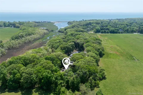 an aerial view of a house with yard