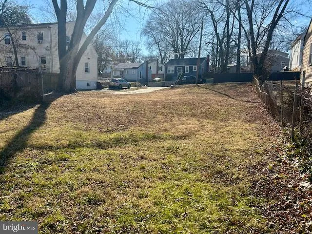a white house covered with snow in front of house