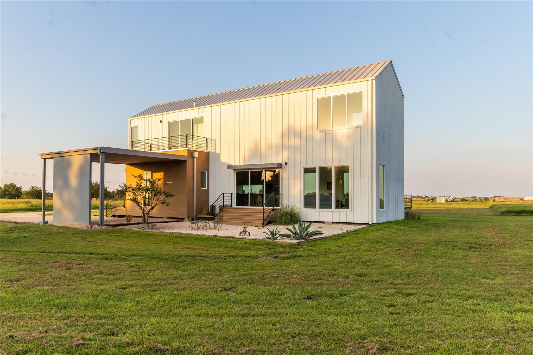 a living room with furniture floor to ceiling window and an outdoor view
