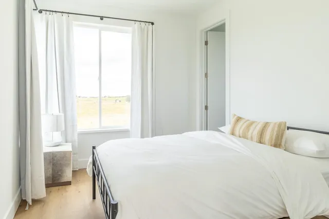 a bedroom with a bed and a window