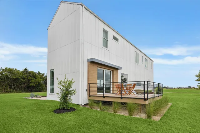 a front view of a house with a yard table and chairs