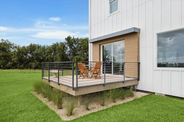 a view of a wooden deck with a yard