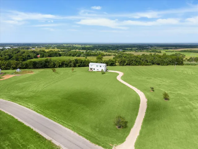 a view of a big yard with a large trees