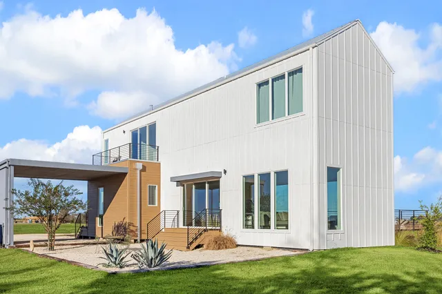 a front view of a house with a yard and porch