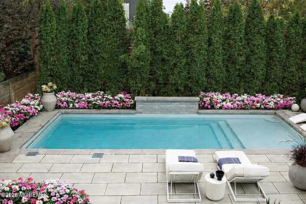 a view of yard with flowers and trees