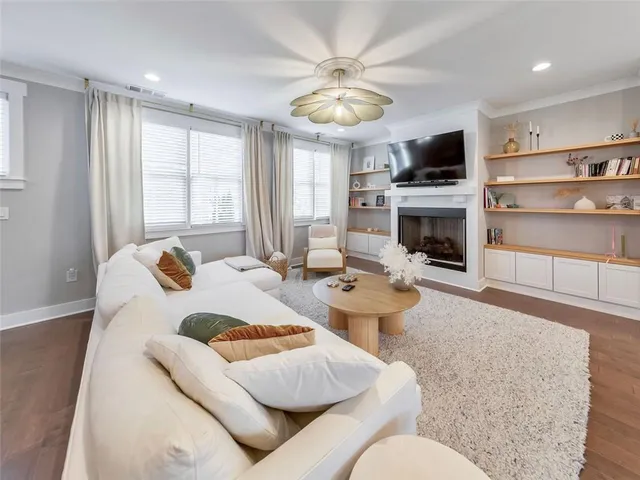 a living room with furniture a fireplace and a flat screen tv
