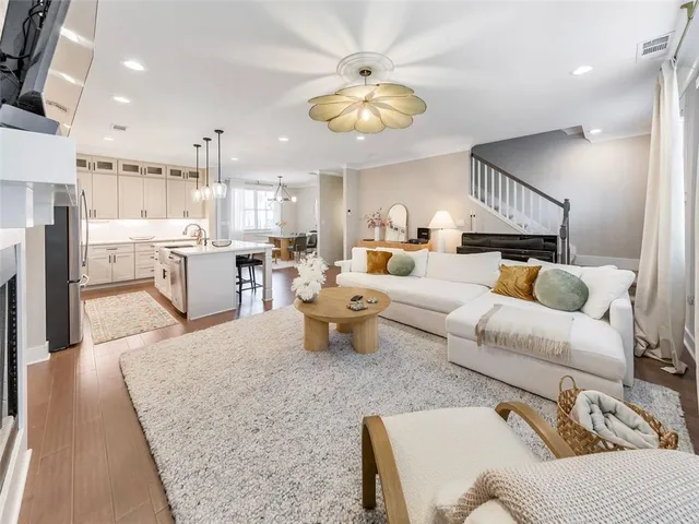a living room with furniture and a chandelier