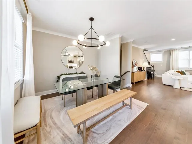 a living room with furniture a chandelier and a wooden floor