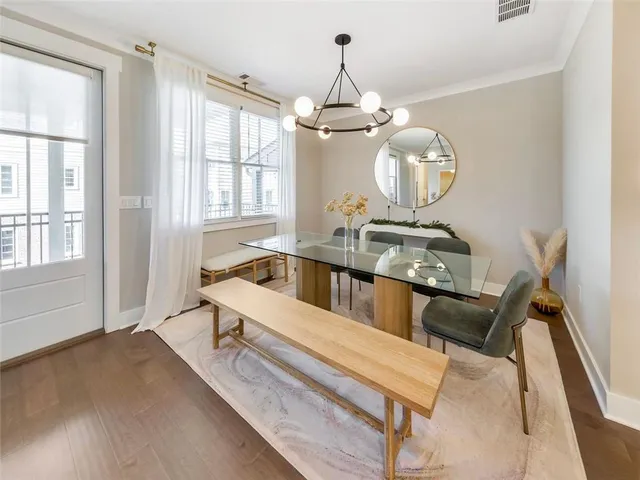 a living room with furniture chandelier and a window