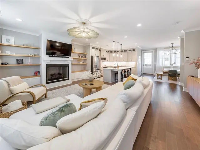 a living room with furniture a fireplace and a flat screen tv
