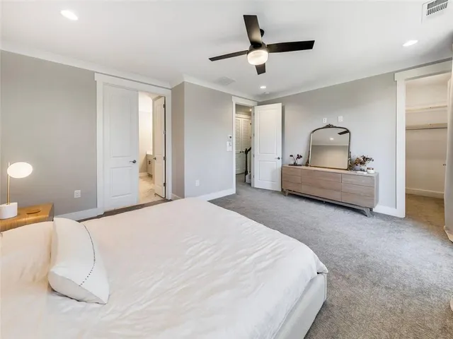 a bedroom with a bed and a large mirror