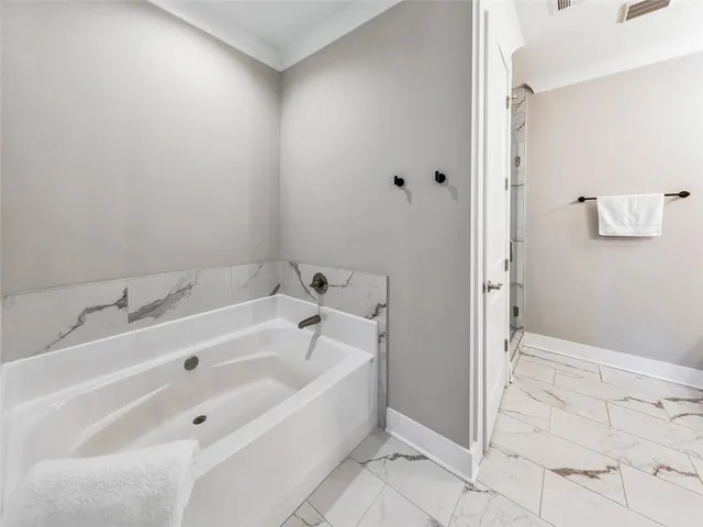 a bathroom with a glass shower door