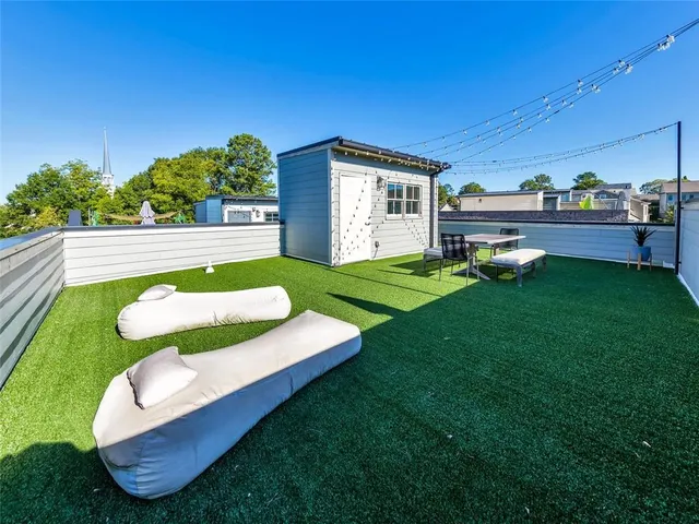 a view of a house with backyard porch and sitting area
