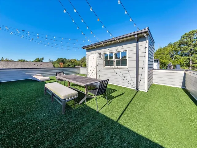 a view of a backyard with sitting area