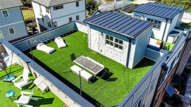 an aerial view of residential houses with outdoor space