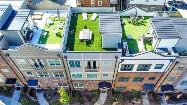 an aerial view of a brick house with a swimming pool