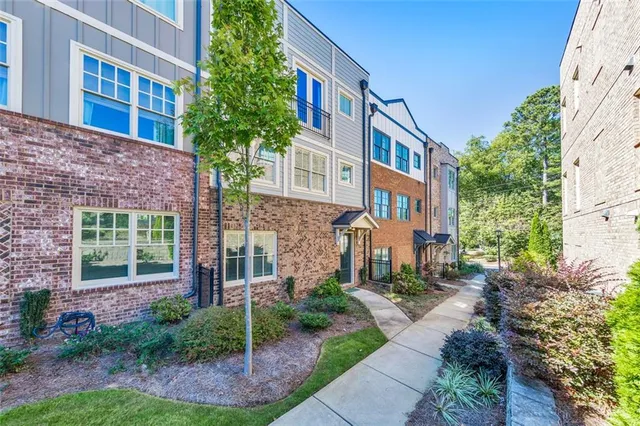 a view of a brick building next to a yard