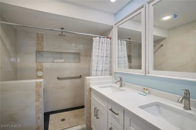 a bathroom with a shower sink and mirror