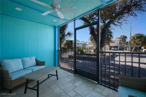 a kitchen with stainless steel appliances granite countertop white cabinets a sink a stove a refrigerator and island with wooden floor