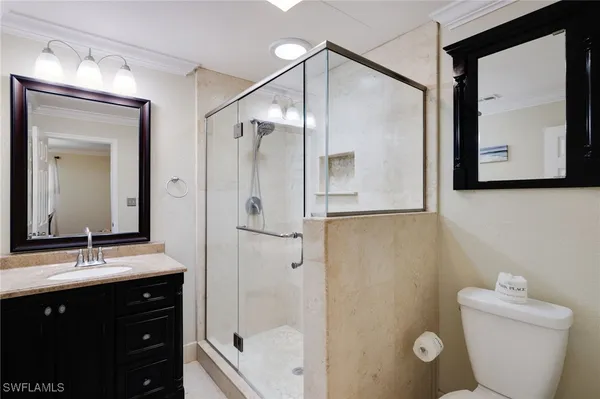a bathroom with a granite countertop sink toilet a large mirror a vanity and shower
