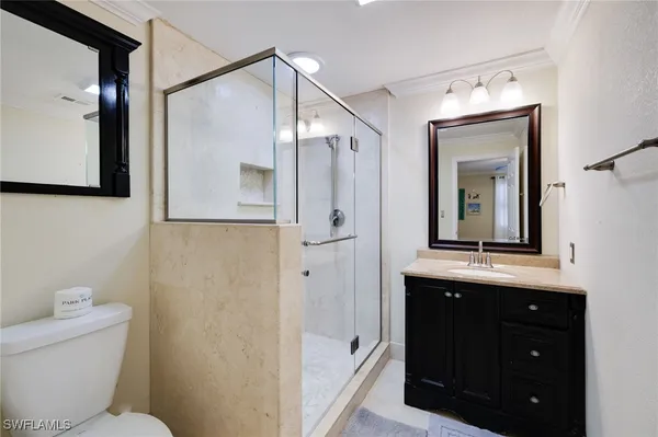 a bedroom with two beds and painting on the wall