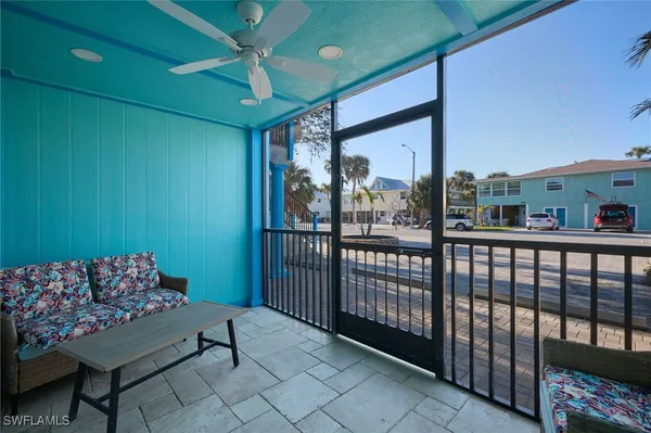 a balcony with furniture and a potted plant