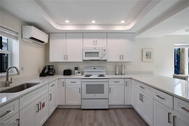 a kitchen with cabinets a sink and appliances