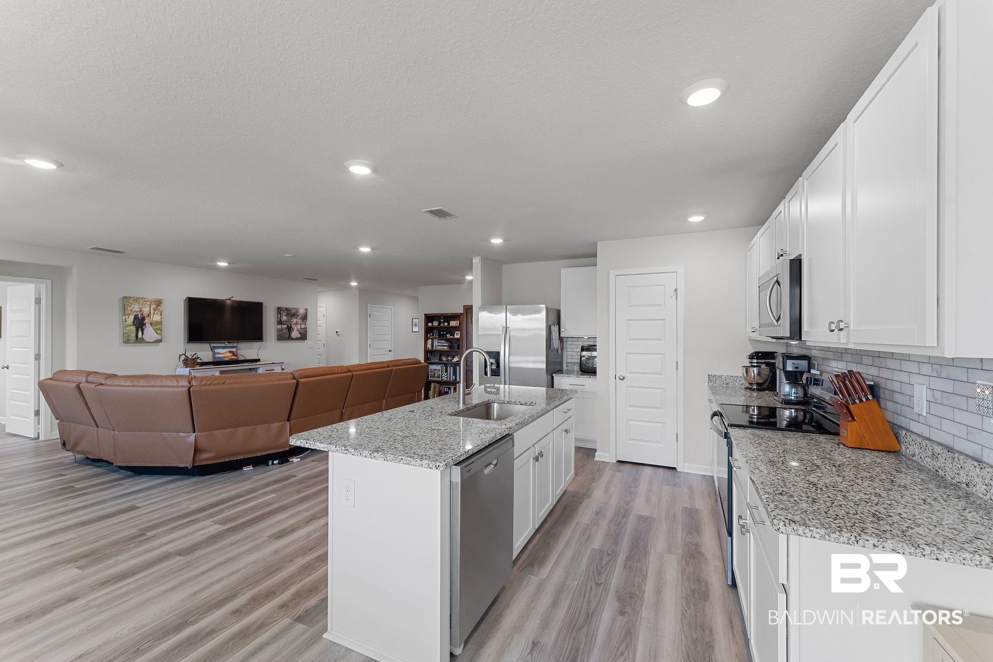 24337 Ringneck Loop Elberta, AL 36530 - Photo 34 of 34 Kitchen with white cabinetry, open floor plan, stainless steel appliances, light wood finished floors, and recessed lighting