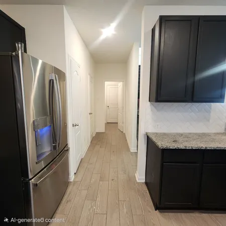 a view of a refrigerator in kitchen and wooden floor