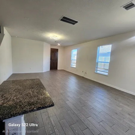an entryway with wooden floor and a rug