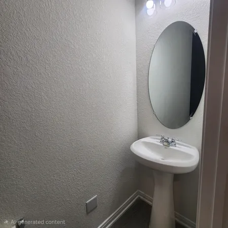 a bathroom with a sink toilet and mirror