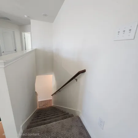a view of a room with white walls and a white door