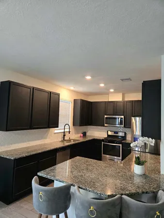 a kitchen with a stove a sink and a refrigerator