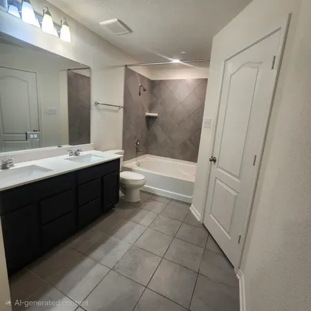 a bathroom with a double vanity sink toilet and shower