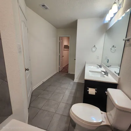 a white toilet sitting next to a bathroom sink