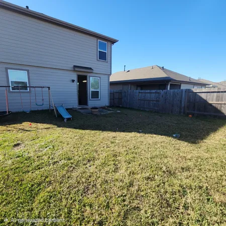a view of a backyard of the house
