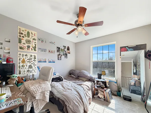 a bed room with bed and a window