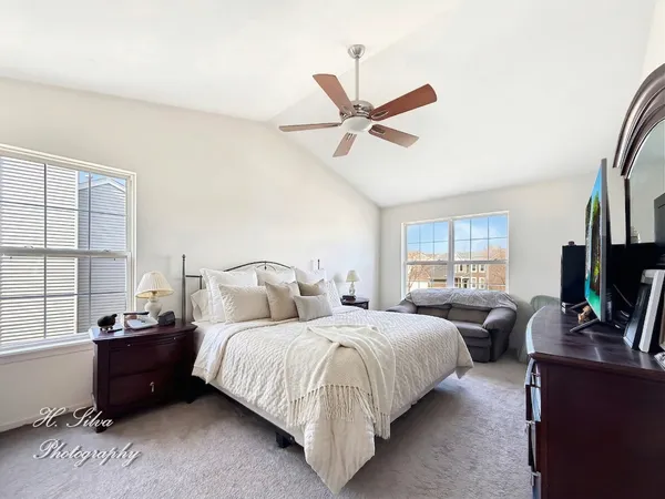 a spacious bedroom with a bed and a window
