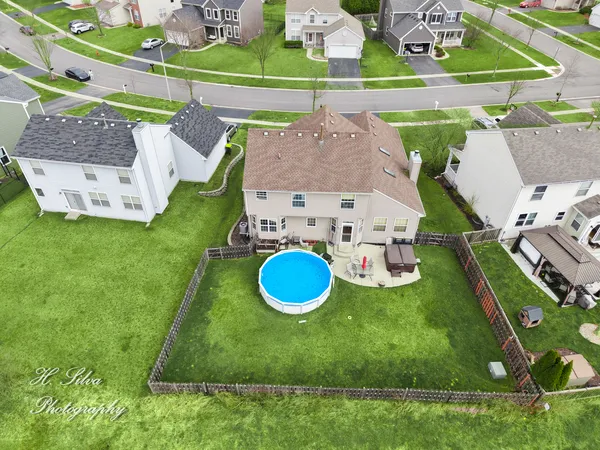 a backyard of a house with lots of green space and plants