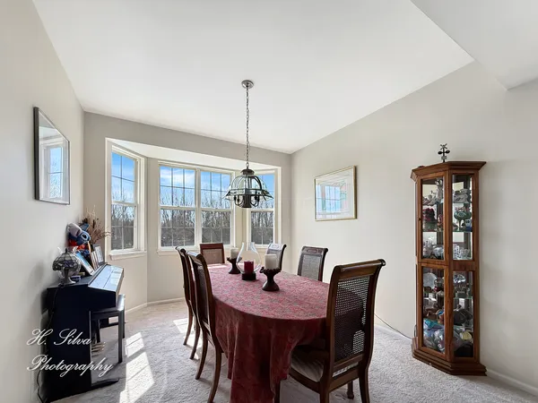 a view of a dining room with furniture and window