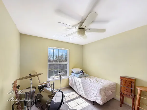 a bedroom with a bed and a chair