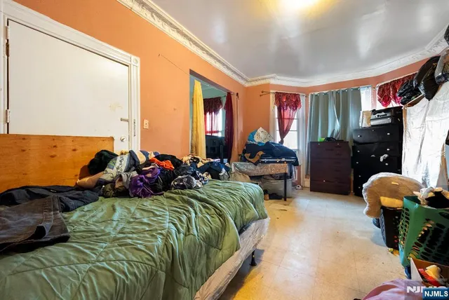 a bedroom with bed and a couch