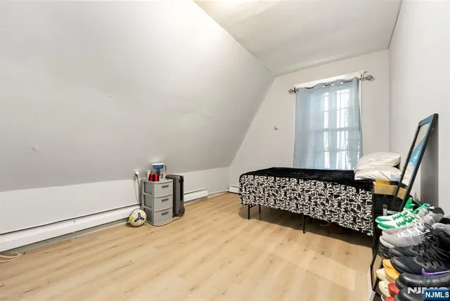 a bed room with a bed and a television