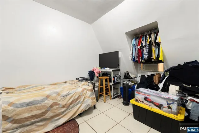 a bedroom with bed and window