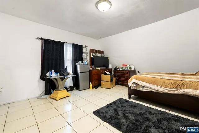 a bedroom with bed and window