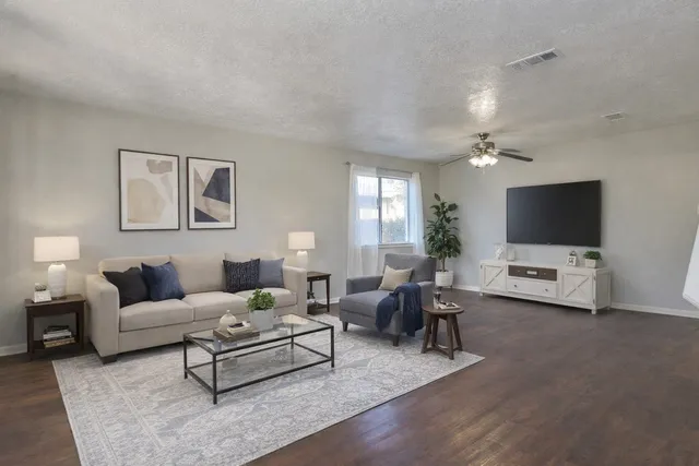 a living room with furniture and a flat screen tv